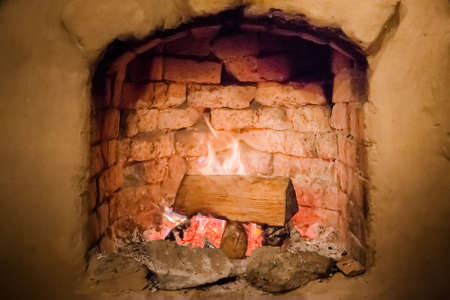 fireplace with burning wood inside nature backgroundの写真素材