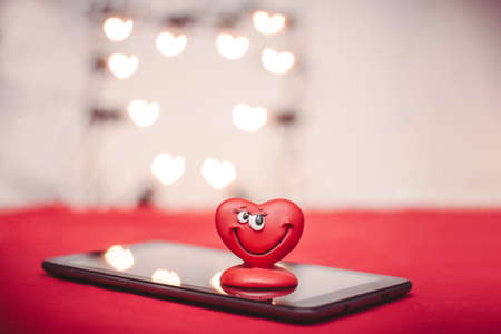 Happy red love heart with heart bokeh on the tablet PC Valentines Day の写真素材
