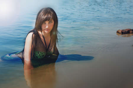 beautiful girl in a bathing suit in the waterの写真素材
