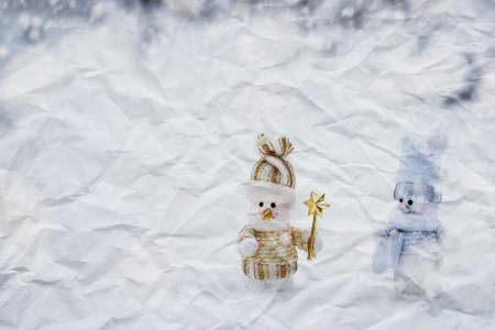 crumpled paper texture. couple of snowmen in the winter woodsの写真素材