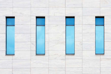 Clouds reflected in windows of modern office buildingの写真素材