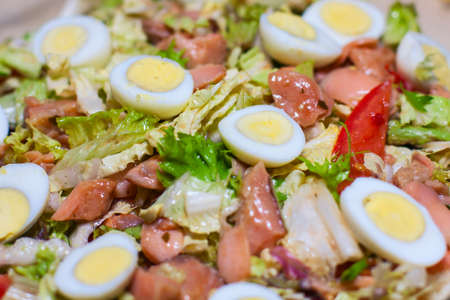 salad with chicken and cheese and quail eggs food backgroundの写真素材