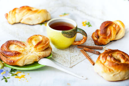 homemade scones and a cup of tea on the tablecloth, food background