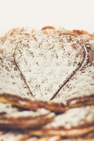 Waffle heart-shaped dusted with icing sugar macro photo
