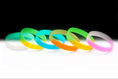 Colored latex glowing light-bracket bracelet on Black Background. Multicolor setの写真素材