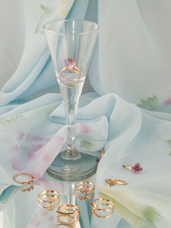  the gold jewellery and the glass is on the mirror の写真素材