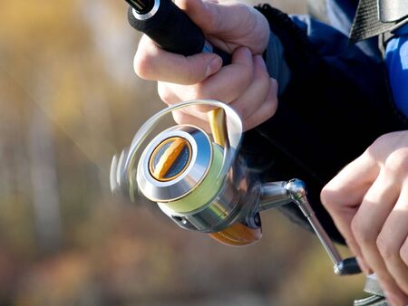 The fisherman with a fishing reelの写真素材