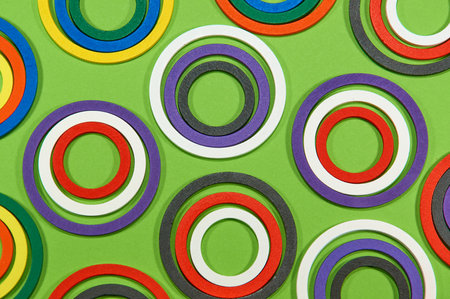 Composition with colored circles. Round background made with wooden rings on green background.の写真素材