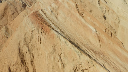 a drone approach to a very beautiful rock of yellow sand color and in the rays of sunlight. An...