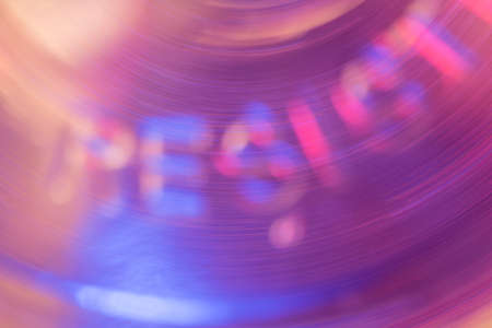 Abstract  A rotating liquid shape forms the blurry letters RESIST in it
