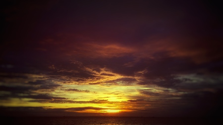 Dusk sky, selective focus on the sun. Low key toned image.