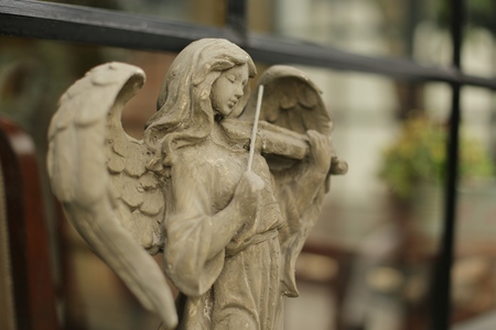 Angel sculpture in the house garden. Selective focus and toned image.の写真素材
