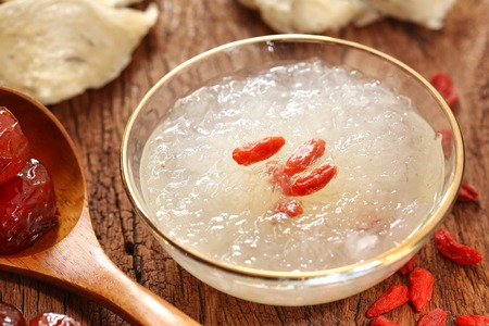 The nest of Edible-Nest Swiftlet, raw edible bird's nest materials for tradition chinese medicine. Edible nest soup is popular at Hong Kong, Taiwan, China and Southeast Asia. Selective focus and free space for text. Edible bird's nest on white background.の写真素材