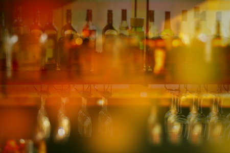 Blurred of Colorful liquor glass bottles at bar, selective focus and free space for text.の写真素材