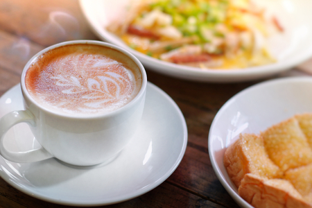Hot coffee on wooden table, The best materials for processing fresh coffee. Porcelain coffee cup on...