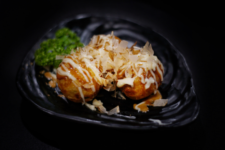 Japanese food: Takoyaki on table. Clean food concept. Toned image. Selective focus and free space for text.の写真素材