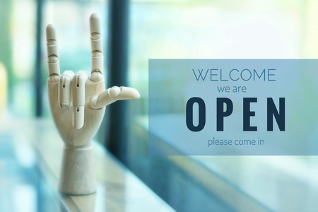 A business text âOpen and Welcomeâ on blurred of cafe or restaurant entrance background. Industry food, Cafe and restaurant idea concept.の写真素材