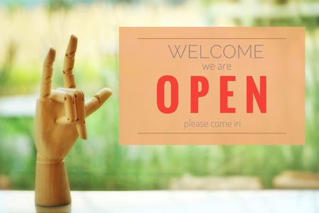 A business text âOpen and Welcomeâ on blurred of cafe or restaurant entrance background. Industry food, Cafe and restaurant idea concept.の写真素材