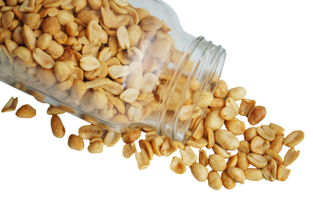 Roasted peanuts in the glass bottle isolated on white background. This image with clipping path for...