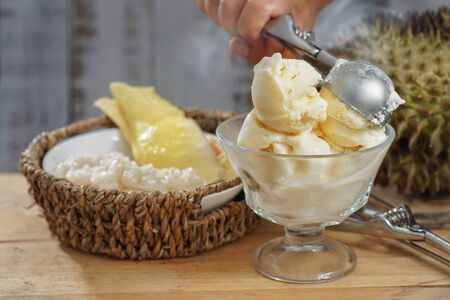 Still life photography of Durian ice cream on the table, shooting in studio. Popular fruit for dessert in Asian served with durian and sticky rice, Tropical dessert fruit concept for advertising.の写真素材