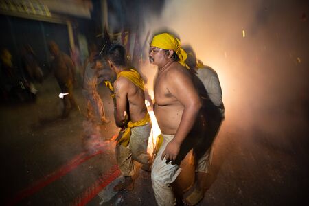 CHONBURI, THAILAND - SEPTEMBER 30, 2019: At night, The parade possessed by his god walking on fire in Vegetarian Festival also known as Nine Emperor Gods Festival. Stop action and motion blur.のeditorial素材