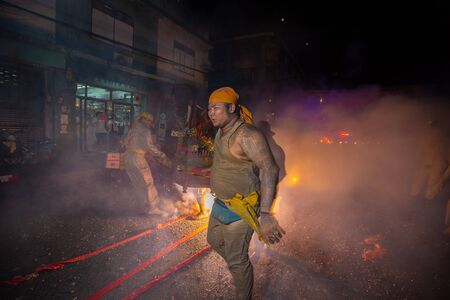 CHONBURI, THAILAND - SEPTEMBER 30, 2019: At night, The parade possessed by his god walking on fire in Vegetarian Festival also known as Nine Emperor Gods Festival. Stop action and motion blur.のeditorial素材