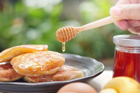Pancakes served honey on table, healthy breakfast for everyday. Clean food good taste for advertising ideas concept.の写真素材