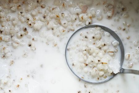 Top view of Job's tears  or Adlay millet seeds for background. Boiled of jobâs tears with coconut milk, Thai dessert with clipping path.の写真素材