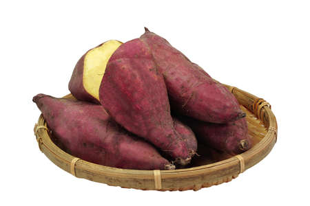 Japanese sweet potatoes or Beni Haruka in bamboo basket isolated on white background. This image stacked  for food advertisement ideas concept.の写真素材