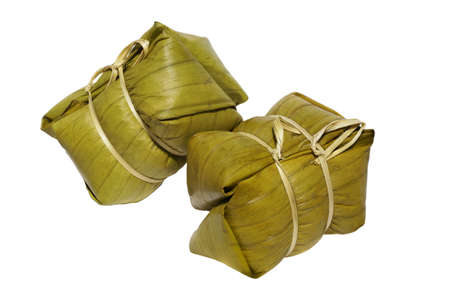 Thai dessert, sticky rice steamed with banana in banana leaf ( Khao Tom Mad or Khao Tom Pad ) in culture market at Thailand, Sticky rice steamed with banana isolated on white background, stacked with  .の写真素材