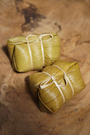 Thai dessert, sticky rice steamed with banana in banana leaf (Khao Tom Mad or Khao Tom Pad) at...