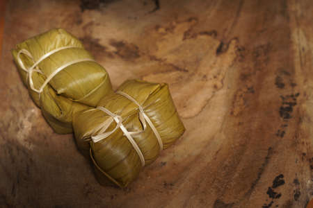 Thai dessert, sticky rice steamed with banana in banana leaf (Khao Tom Mad or Khao Tom Pad) at Thailand, Sticky rice steamed with banana isolated on white background, stacked with  .の写真素材