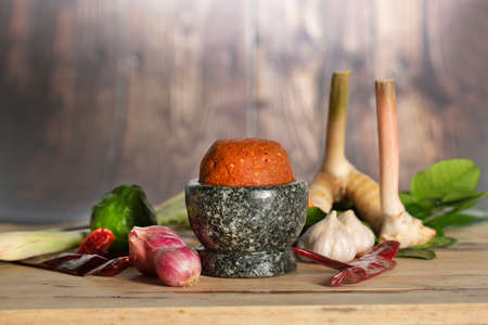 Still life photography of Lemon, ginger, chili, lemongrass, galangal, kaffir lime leafs on table, Thai herbs, Ingredient for cooking healthy Thai food. Healthy food concept. Copy spaceの写真素材