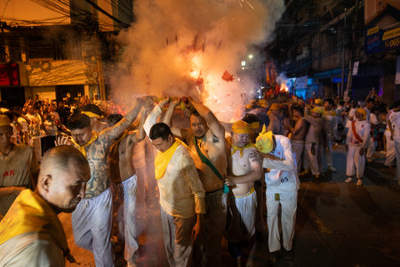 CHONBURI, THAILAND - OCTOBER 4, 2024 : At night, The parade possessed by his god walking on fire in...