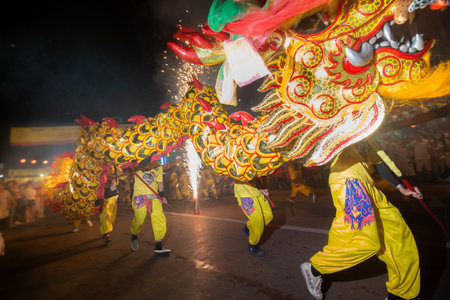 CHONBURI, THAILAND - OCTOBER 4, 2024 : At night, The parade possessed by his god walking on fire in...