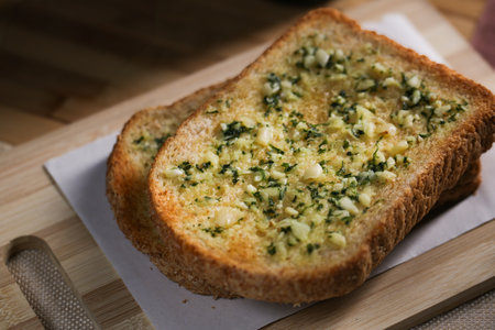 Garlic bread with herbs, Toasted bread with garlic and herbs isolated on white background. This image is stacked with clipping path for advertisementの写真素材