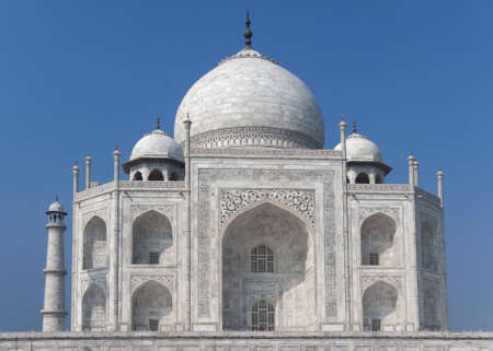 White marble monument against blue skies and with one minaret.の写真素材