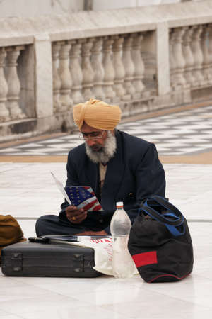 New Delhi - March 2011 - Sikh emigrant, sitting on the pavement,  studies how to get legally into the USA. のeditorial素材