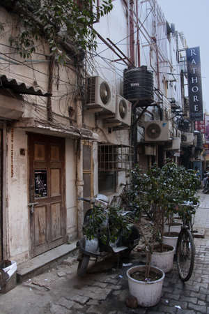 Khan Market in New Delhi - March 2011 - Utilities (electrical, airco, water, cable. etc) disfigure the front of businesses in what is supposed to be an upscale neighborhoodのeditorial素材