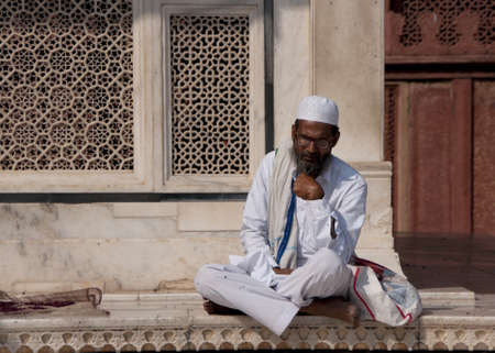 Indian town of Fatehpur - February 2011 - Sufi Muslim Cleric studies Holy texts outside the Jama...