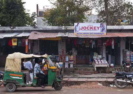 Agra In India - February 2011 - Street view with small shops and motor rickshaw.