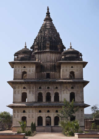 Blackened domes over white beige wall with multiple open arches against blue skies.のeditorial素材