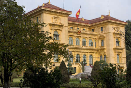 Presidential Palace in garden and with flag  Mansion in amber colored stones against pale blue skies のeditorial素材