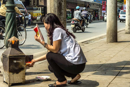 Vietnam Hanoi - March 2012: Burning fake money to please the commercial spirits.のeditorial素材