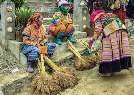 Hmong women selling brooms on Sunday market. Colorful appearance.のeditorial素材