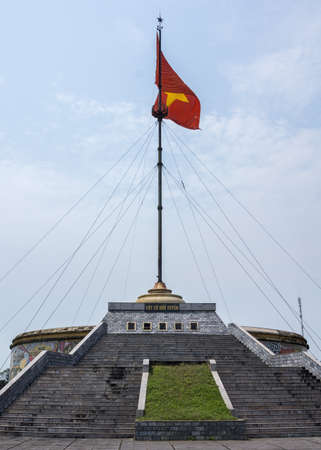 Stairs lead up to the tall flag pole where the national symbols waves in the windのeditorial素材