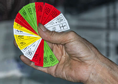 Vietnam: Hand playing the four-colors cardgame Si Se Pai.の写真素材