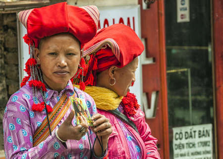 Vietnam Sapa - March 2012: Hmong females of Red Dao tribe in the streets of town.のeditorial素材