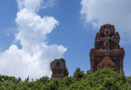 Vietnam: Banh It Cham towers against blue skies with white clouds.の写真素材