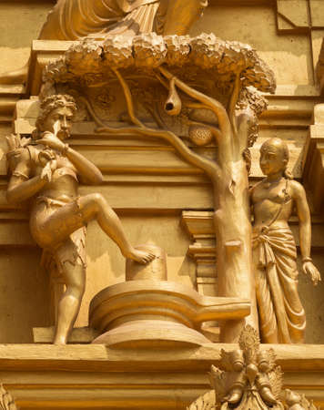 Statue on the golden temple tower of Sri Naheshwara in Bengaluru depicts Kannappa Nayanar, the hunter that donates his eyes to honor Lord Shiva のeditorial素材